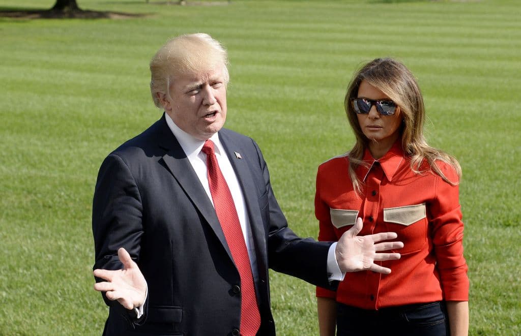 WASHINGTON, DC - SEPTEMBER 10: (AFP OUT) US President Donald Trump talks to members of the media about Hurricane Irma as first lady Melania Trump looks on upon arrival on the South Lawn of the White House September 10, 2017 in Washington, DC Trump spent the weekend at Camp David, the Presidential retreat in Maryland. (Photo by Olivier Douliery-Pool/Getty Images)