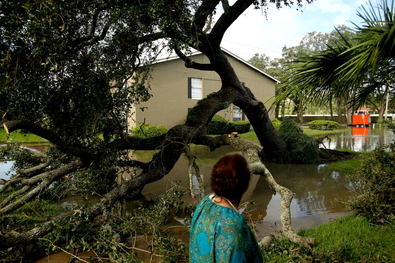 ALTAMONTE SPRINGS, FL - SEPTEMBER 11: A resident inspects flooding and damage left behind in the wake of Hurricane Irma at her apartment complex, the Oaks of Spring Valley, on September 11, 2017 in Altamonte Spring, Florida. Hurricane Irma made landfall as a Category 4 storm twice in the United States on Sunday after tearing a path across islands in the Caribbean Sea. (Photo by Brian Blanco/Getty Images)
