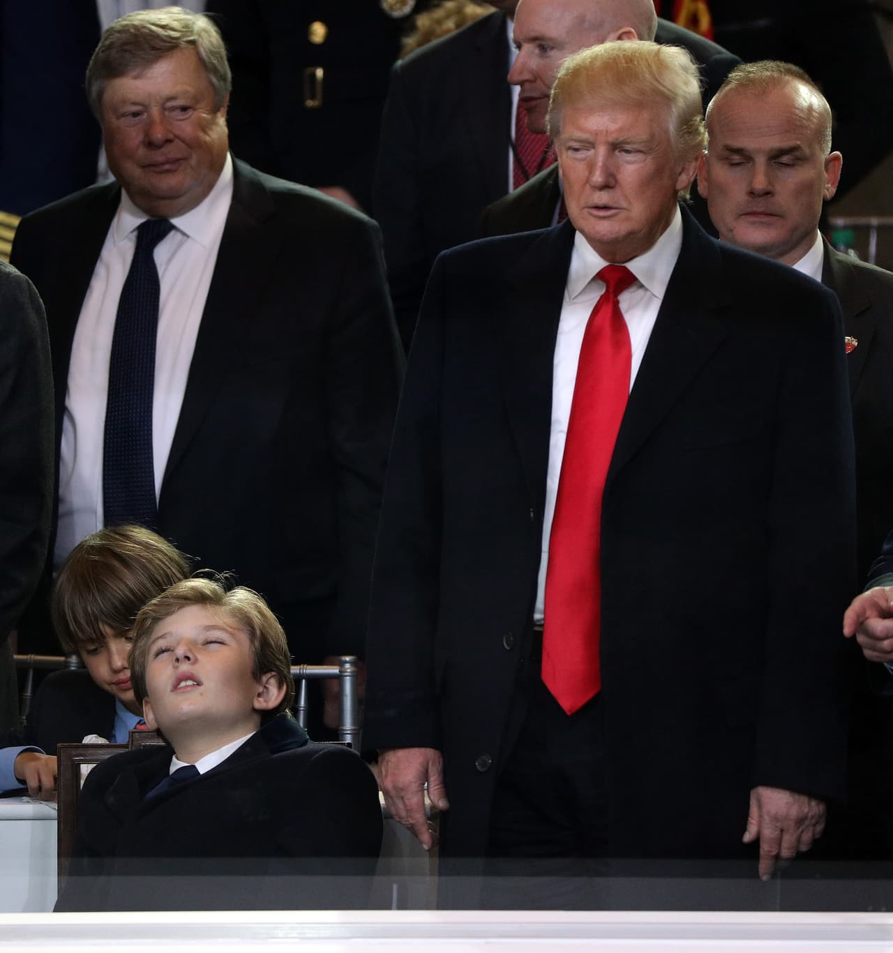 WASHINGTON, DC - JANUARY 20: U.S. President Donald Trump (R) and Barron Trump watch the Inaugural Parade from the main reviewing stand in front of the White House on January 20, 2017 in Washington, DC. Donald J. Trump was sworn in today as the 45th president of the United States. (Photo by Patrick Smith/Getty Images)