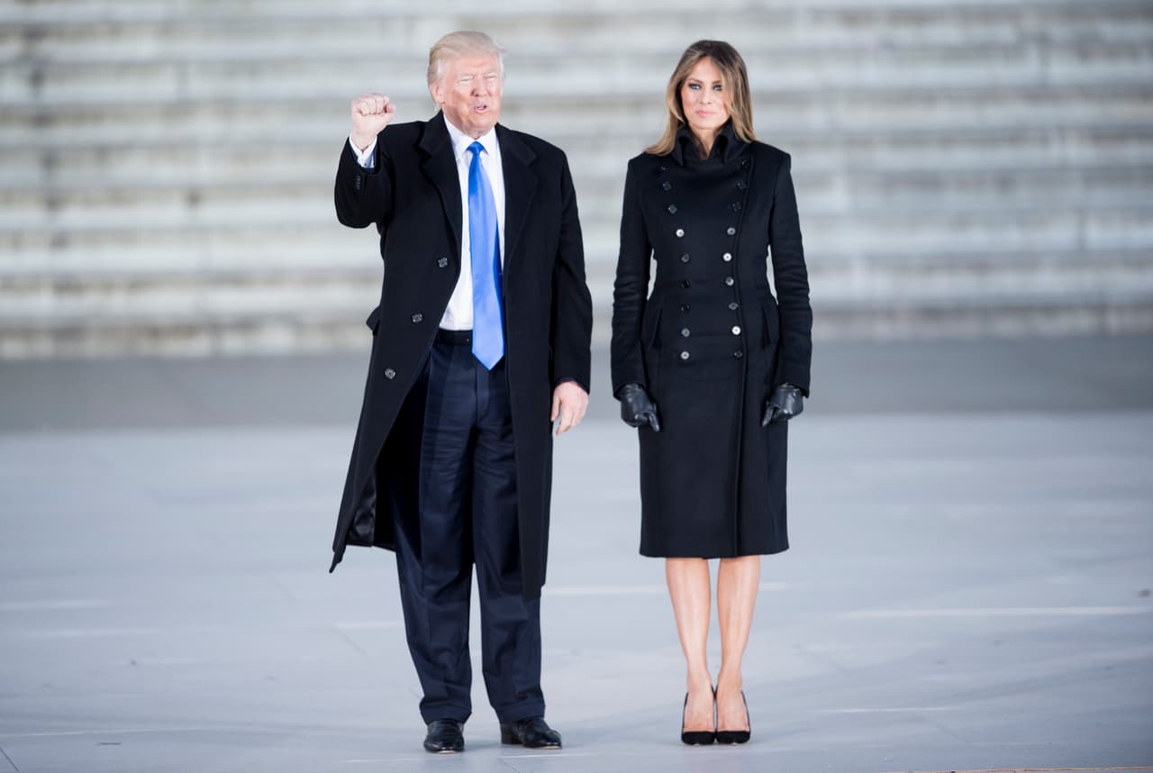 En el día del jueves, para la visita al cementerio Arlington, Melania eligió un vestido tipo gabardina negro de doble abotonadura, que parecía ir acorde con la ocasión que pretendía homenajear a los soldados caídos en guerra. Justamente, su traje creado por Norisol Ferrari era en si mismo un homenaje. La diseñadora de origen latino es hija de un veterano muerto en combate.