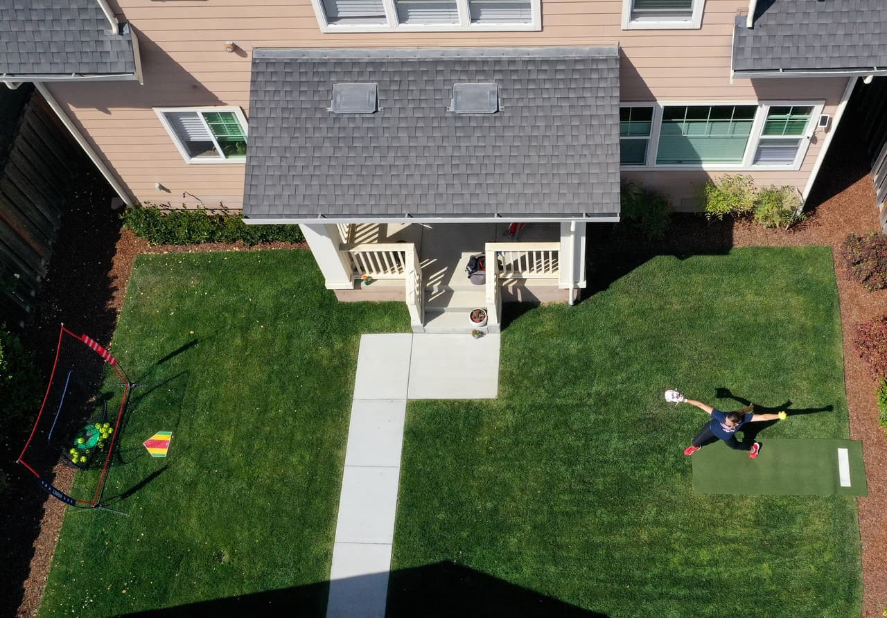 <b>Activos en el confinamiento.</b> Muchos atletas tuvieron que continuar sus entrenamientos en casa para evitar enfermarse y propagar el virus. En esta fotografía la sofbolista olímpica Monica Abbott realiza una sesión de práctica en su patio, en Salinas, California. 2 de junio.