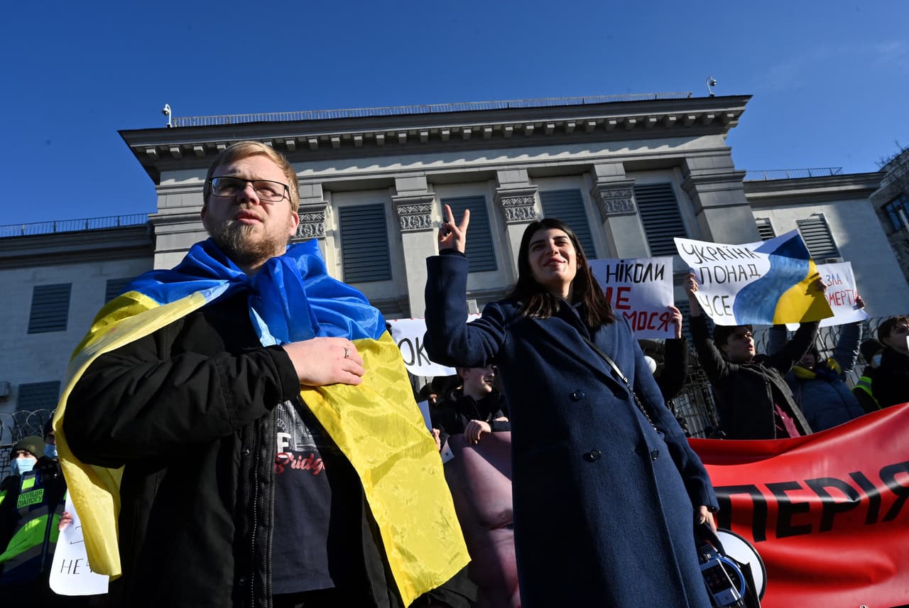 Activistas ucranianos sostienen pancartas y gritan consignas durante una manifestación frente a la embajada rusa en Kiev el 22 de febrero de 2022. "El imperio debe morir", gritan en rechazo a Putin.