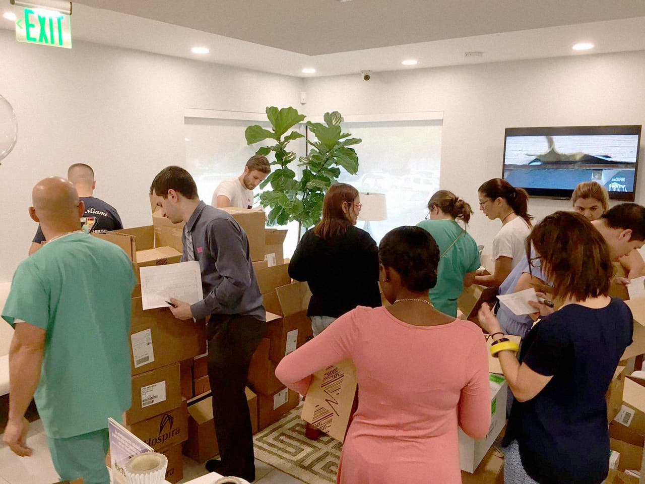 The group of Doctors4PuertoRico finish packing a shipment for several hospitals in Puerto Rico. The doctors on the island pass on specific requests for what they need, and the doctors in Miami raise the funds to get it to them.