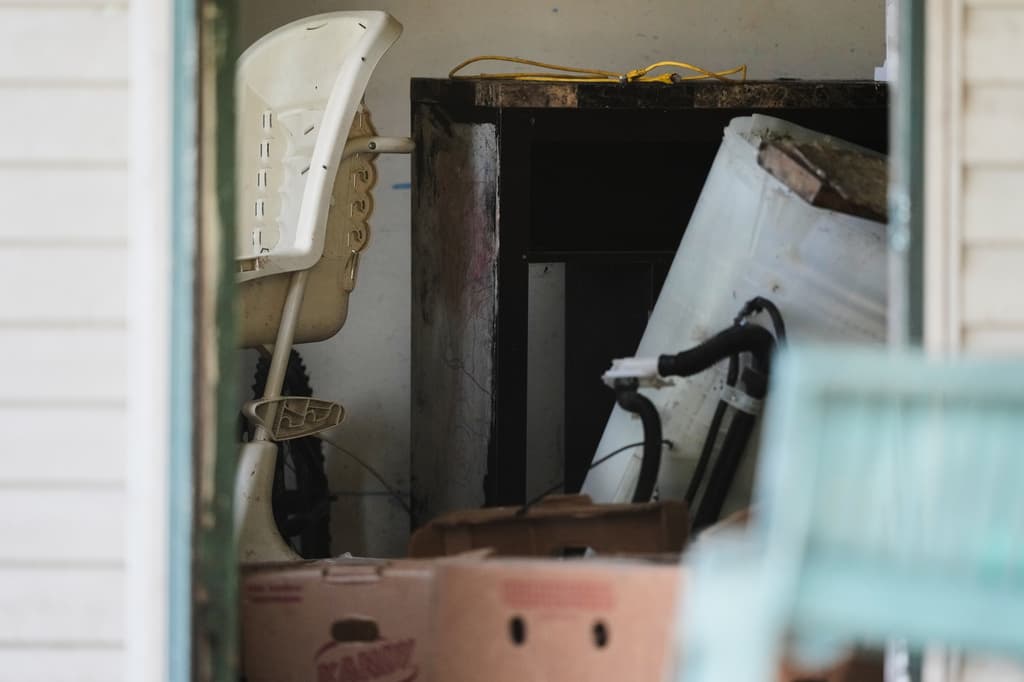 Se observan diversos objetos, incluida una silla alta (a la izquierda), en una vivienda de Hamden, Ohio, donde las autoridades informaron haber retirado a 16 niños y detenido a cuatro adultos el miércoles 1 de julio de 2026. (Foto AP/Carolyn Kaster)