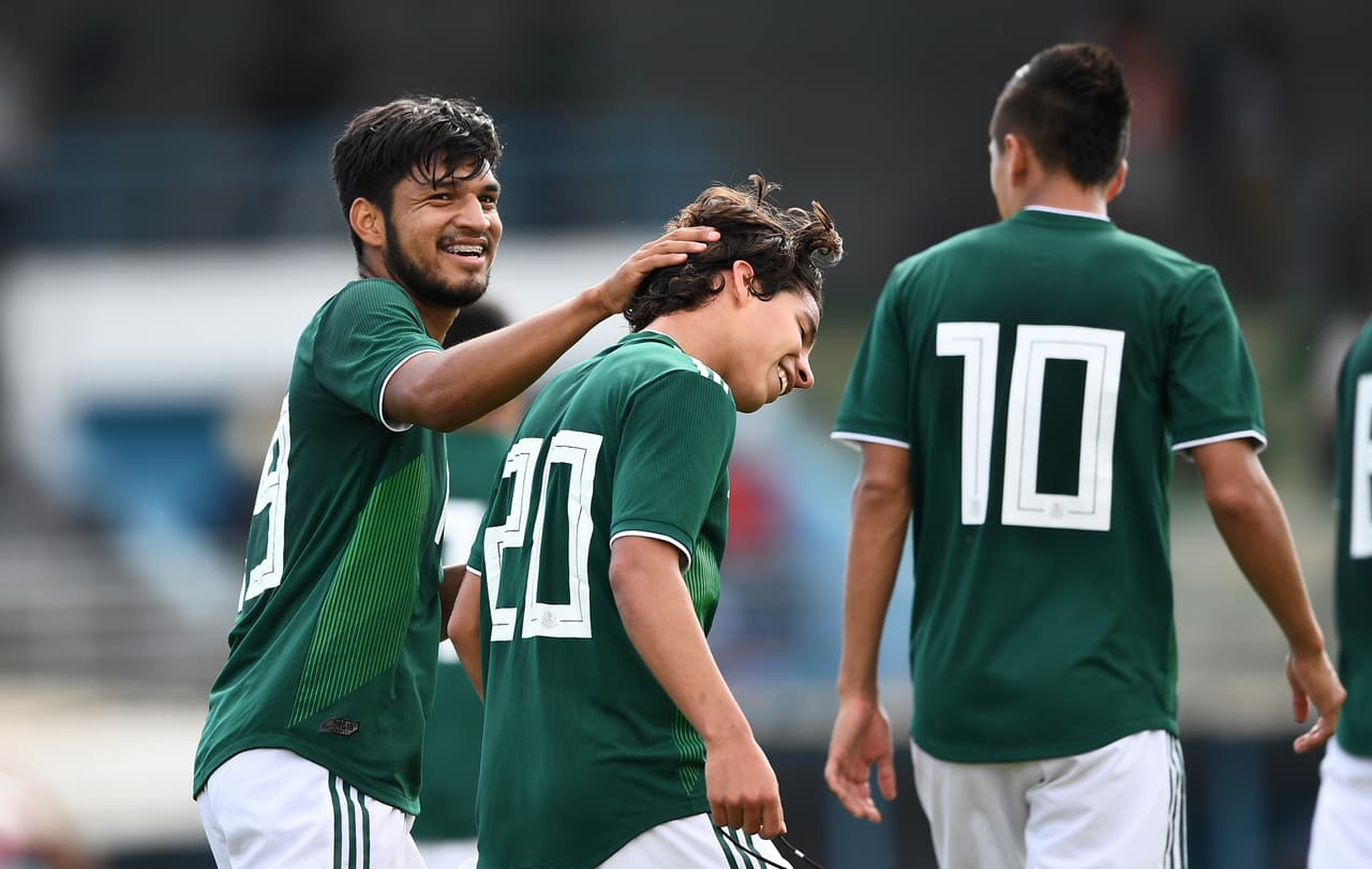 Mexico's Eduardo Daniel Aguirre Lara (L) celebrates with Mexico's midfielder Diego Leyva Lainez (C) after scoring a goal during the Festival International Espoirs - Maurice Revello Tournament Under 21 semi-final football match between Mexico and Turkey at the De Lattre Stadium in Aubagne, southeastern France, on June 6, 2018. (Photo by Anne-Christine POUJOULAT / AFP) (Photo credit should read ANNE-CHRISTINE POUJOULAT/AFP/Getty Images)