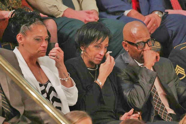Elizabeth Alvarado, Evelyn Rodriguez and Freddy Cuevas, parents of children who were murdered by MS-13 watch as U.S. President Trump delivers the State of the Union address in the chamber of the U.S. House of Representatives January 30, 2018 in Washington, D.C.