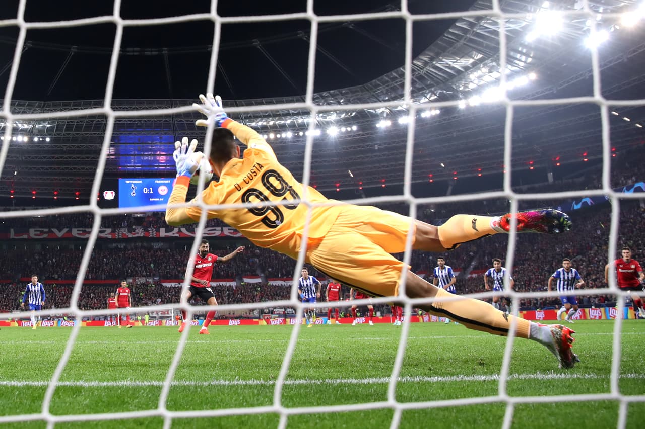 LEVERKUSEN, GERMANY - OCTOBER 12: Diogo Costa of FC Porto saves a penalty kick from Kerem Demirbay (obscured) of Bayer Leverkusen during the UEFA Champions League group B match between Bayer 04 Leverkusen and FC Porto at BayArena on October 12, 2022 in Leverkusen, Germany. (Photo by Alex Grimm/Getty Images)
