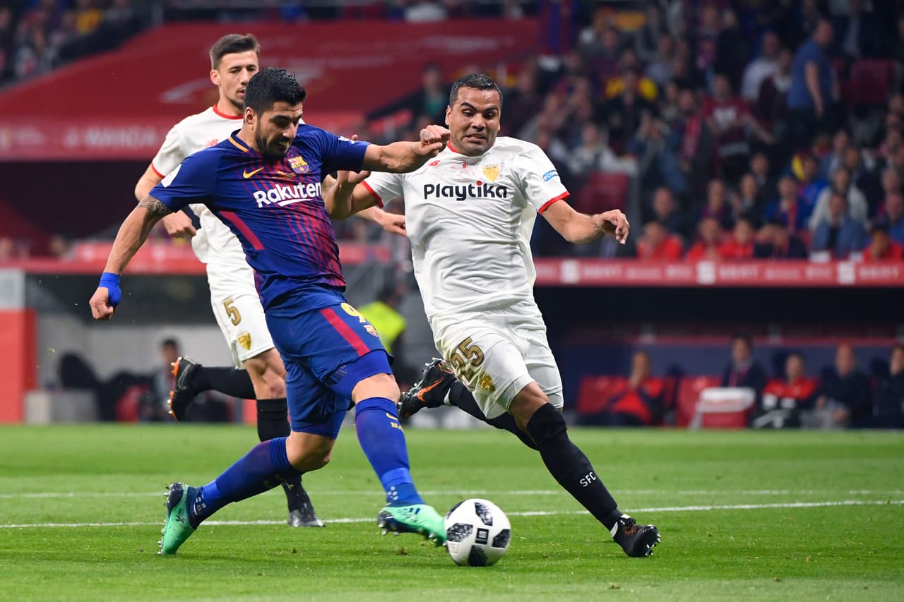 Barcelona's Uruguayan forward Luis Suarez (L) scores during the Spanish Copa del Rey (King's Cup) final football match Sevilla FC against FC Barcelona at the Wanda Metropolitano stadium in Madrid on April 21, 2018. (Photo by PIERRE-PHILIPPE MARCOU / AFP) (Photo credit should read PIERRE-PHILIPPE MARCOU/AFP/Getty Images)