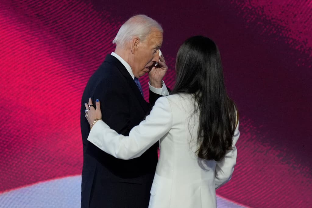 President Joe Biden, left, wipes his eyes after embracing his daughter Ashley Biden, right, on stage at the Democratic National Convention on Monday, Aug. 19, 2024, in Chicago. (AP Photo/J. Scott Applewhite)