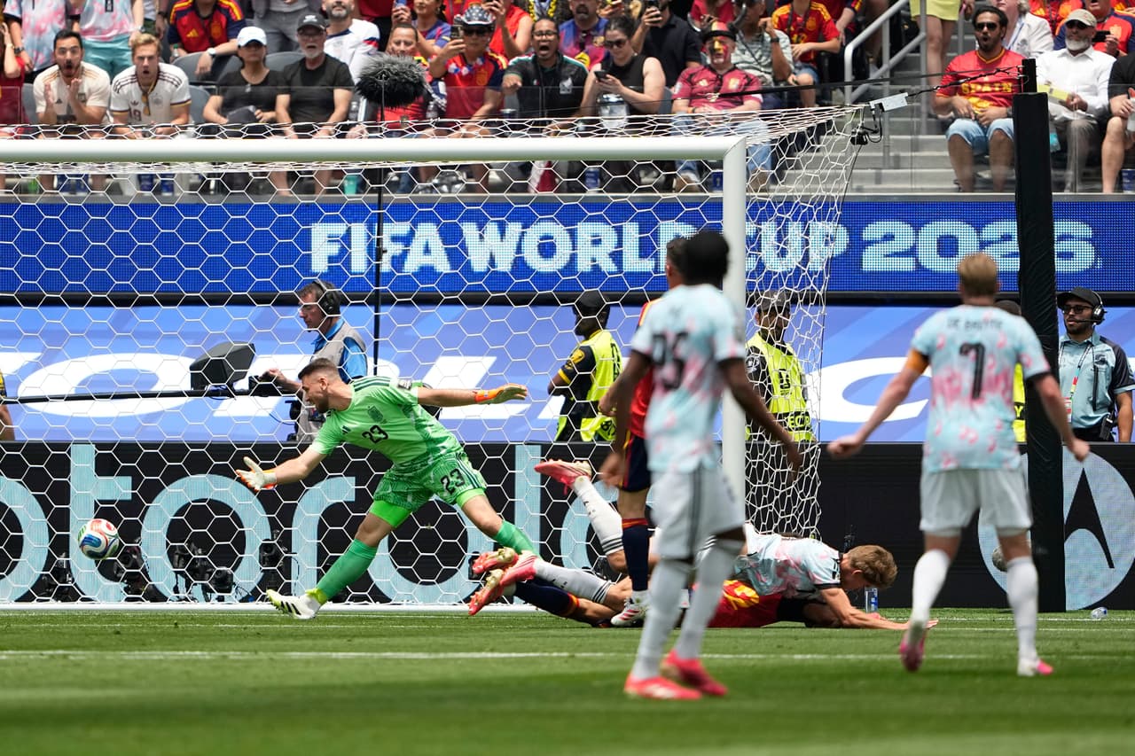 Spain goalkeeper Unai Simon (23) fails to stop the ball as Belgium's Charles De Ketelaere (17) scores his side's opening goal during the World Cup quarterfinal soccer match between Spain and Belgium in Inglewood, Calif., near Los Angeles, Friday, July 10, 2026. (AP Photo/Lindsey Wasson)