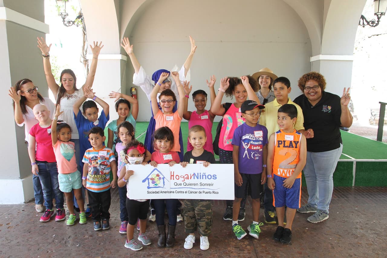 Niñas y niños acompañados de sus padres y de Barbara Díaz, directora de asuntos pediátricos del Hogar Niños que Quieren Sonreir, y empleados de la Compañía de Turismo.