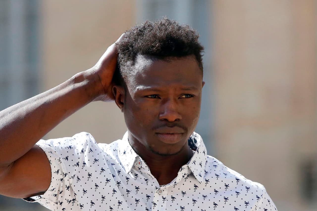 A 22-year old Mamoudou Gassama from Mali leaves the presidential Elysee Palace after his meeting with French President in Paris, on May, 28, 2018. - Mamoudou Gassama living illegally in France is being honored by French President for scaling an apartment building on May 26 to save a 4-year-old child dangling from a fourth-floor balcony. (Photo by Thibault Camus / POOL / AFP) (Photo credit should read THIBAULT CAMUS/AFP/Getty Images)