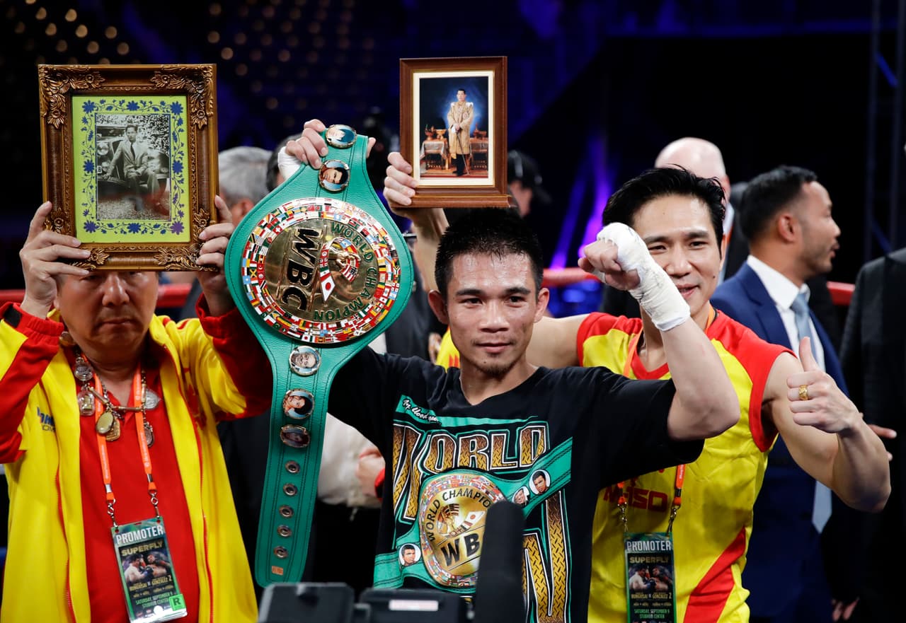 Srisaket Sor Rungvisai, of Thailand, poses for photos after knocking out Roman Gonzalez, of Nicaragua, during the fourth round of the WBC super flyweight championship boxing match Saturday, Sept. 9, 2017, in Carson, Calif. (AP Photo/Chris Carlson)