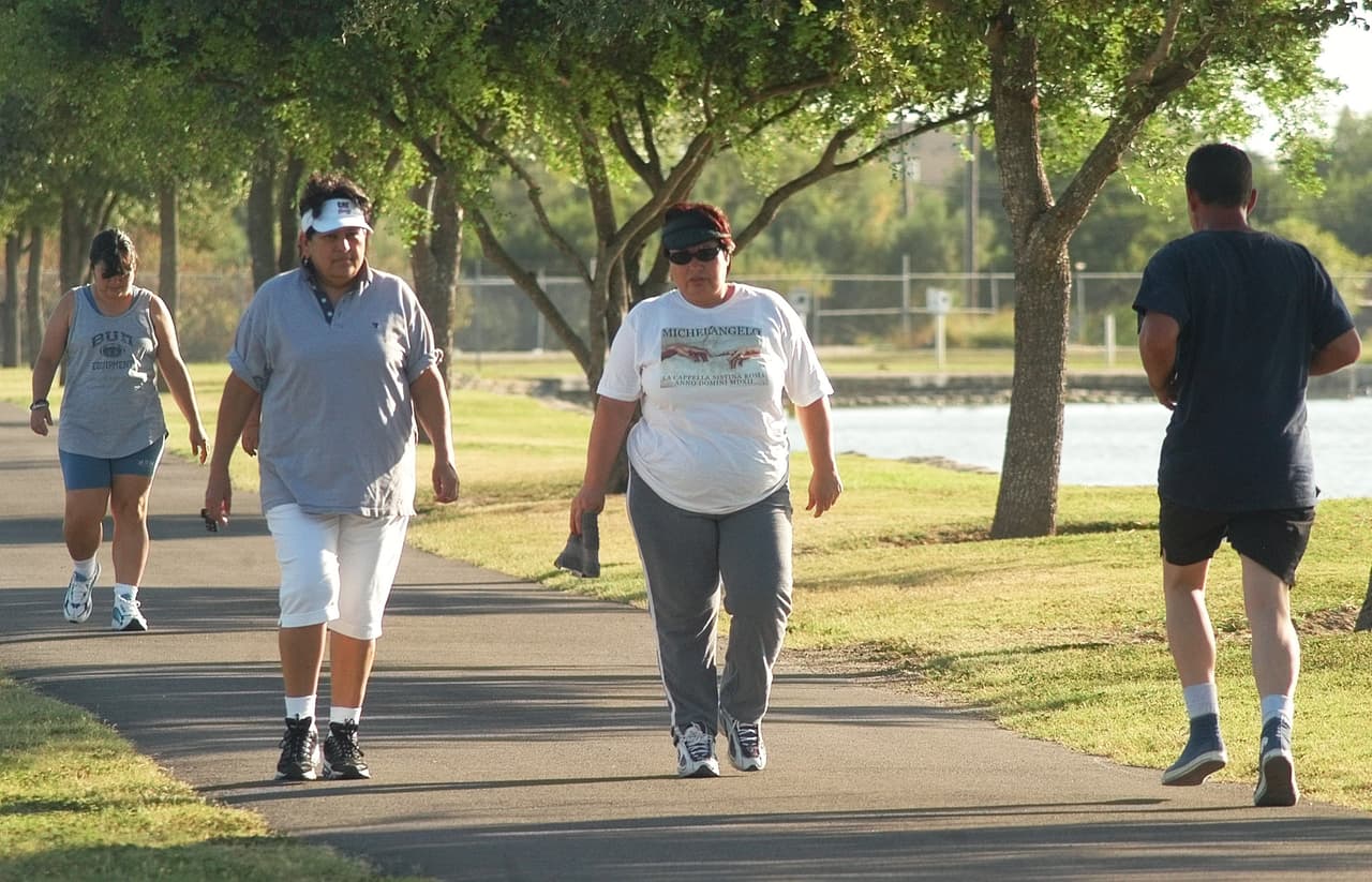 People exercise in the late afternoon around Lake Harlingen in Harlingen, Texas Wednesday, Aug. 25, 2004, by walking around the lake. The four-county Rio Grande Valley region may be one of the unhealthiest areas in America, with the nation's highest rates for cervical cancer and overweight children, according to a study released Wednesday. (AP Photo/Joe Hermosa)
