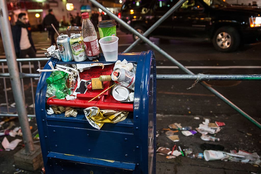 NEW YORK, NY - DECEMBER 31: An over-stuffed postal service box, being used as a garbage can, is seen after ringing in the new year in Times Square on January 1, 2016 in New York City. The New York Police Department will have more than 6,000 officers in the Times Square area, including more than 1,100 officers who graduated from the police academy on Tuesday. It will be the largest such deployment of police in New York City ever. (Photo by Andrew Burton/Getty Images)