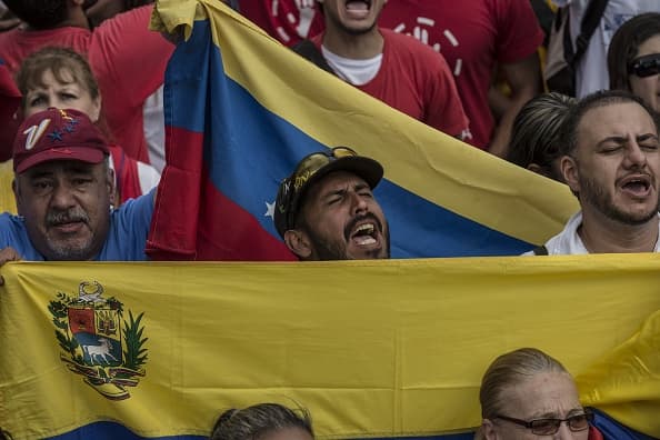 CARACAS, VENEZUELA - JANUARY 23: An opposition sings the National Hymn of Venezuela during a mass rally against Nicolas Maduro in Caracas, Venezuela on January 23, 2019. President Donald Trump recognized Juan Guaido, president of National Assembly, as interim president, just after Guaido declared himself interim president in front of the crowd. (Photo by Marcelo Perez Del Carpio/Anadolu Agency/Getty Images)