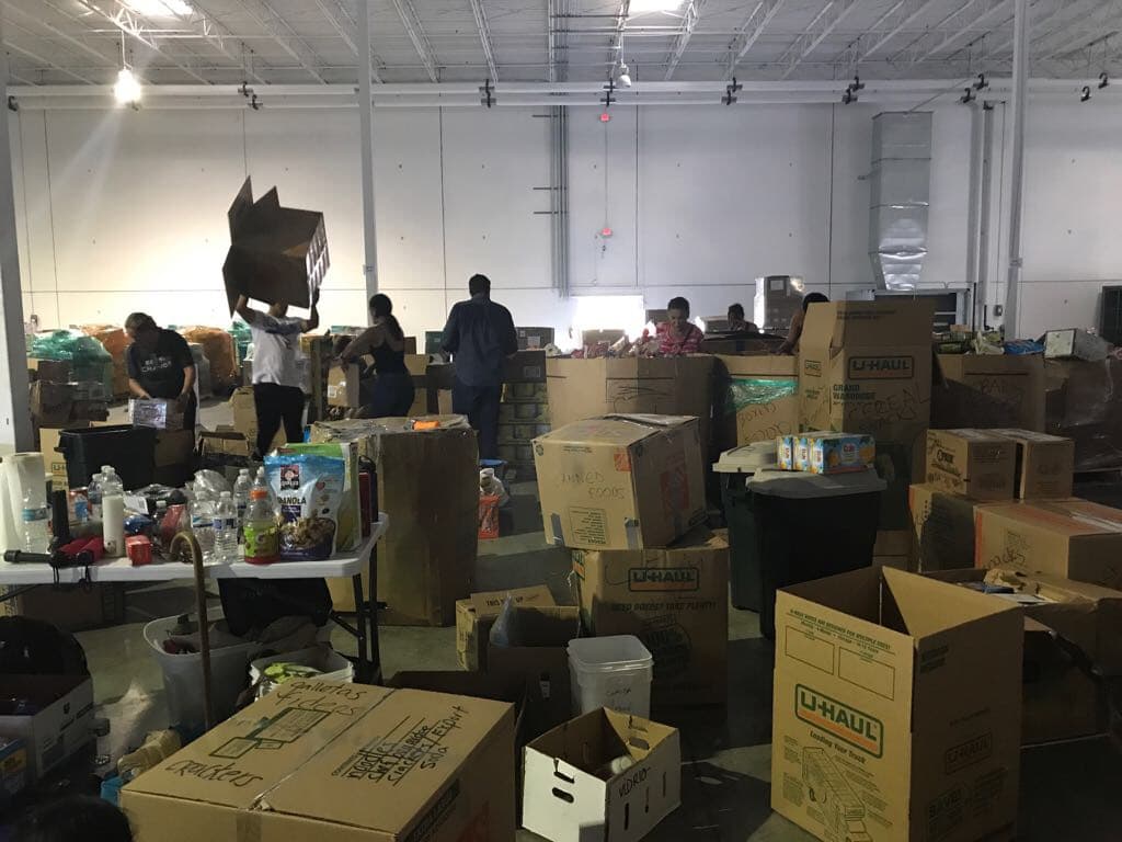 The scene at Mana Wynwood, a warehouse in Miami's Wynwood district, known as Little San Juan. Bottled water, diapers, batteries, flashlights, baby food, canned food, toileteries etc. Photo by Ines Lozano.