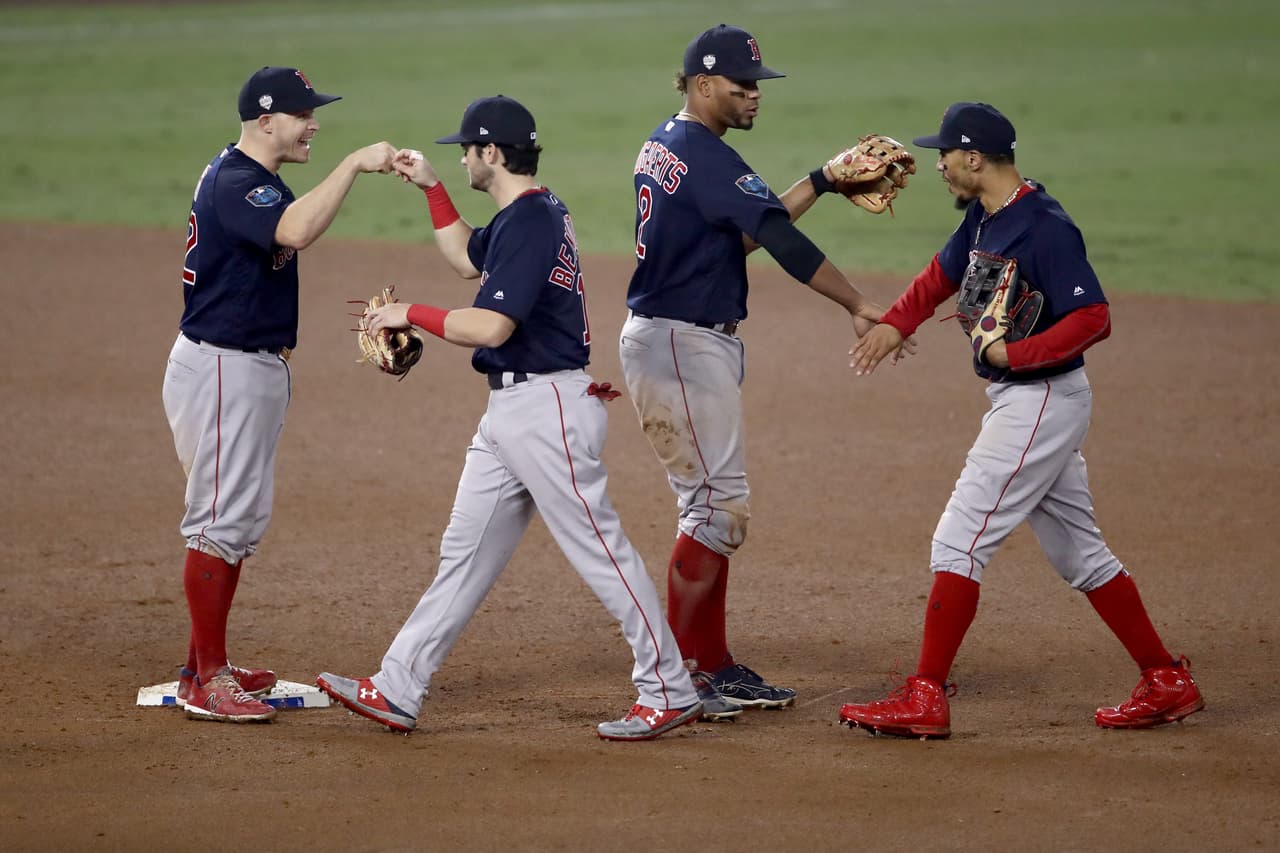 LOS ANGELES, CA - OCTOBER 27: (LR) Brock Holt #12, Andrew Benintendi #16, Xander Bogaerts #2 and Mookie Betts #50 of the Boston Red Sox celebrate after defeating the Los Angeles Dodgers 9-6 in Game Four of the 2018 World Series at Dodger Stadium on October 27, 2018 in Los Angeles, California. (Photo by Ezra Shaw/Getty Images)