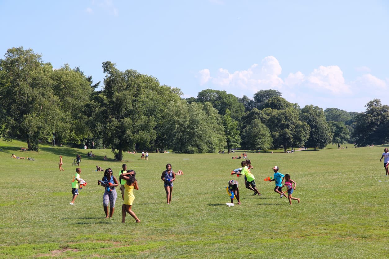 Young people enjoy sunny day in Prospect Park on July 6, 2013 in Brooklyn, New York. The famous public park dates back to 1867 and has an area of 585 acres.