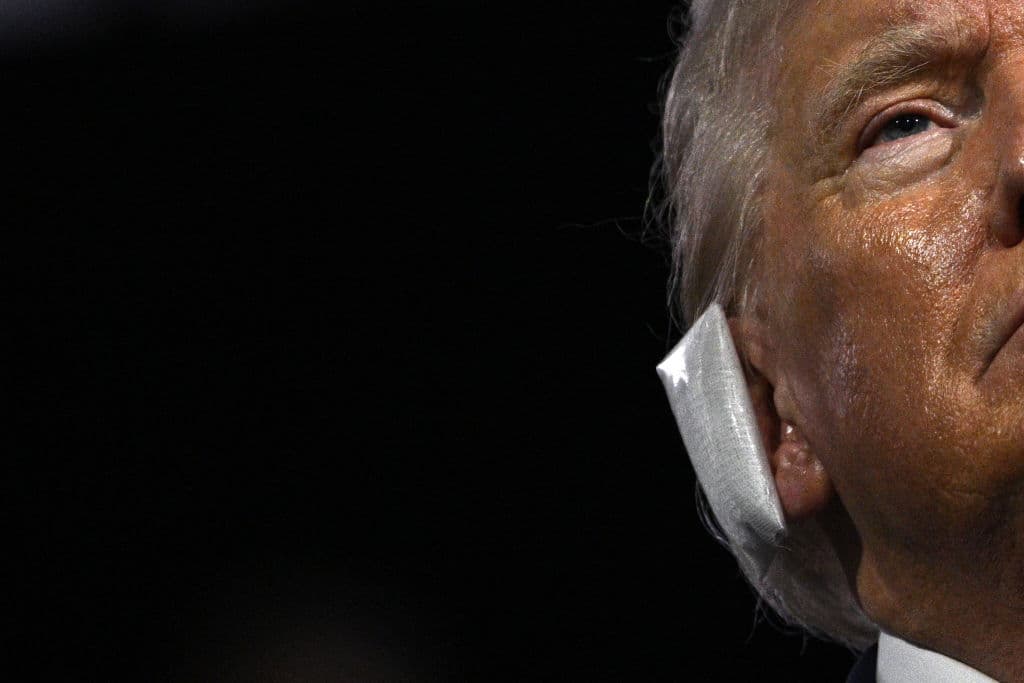 TOPSHOT - A bandage is seen on the ear of US former President and 2024 Republican presidential candidate Donald Trump after he was wounded in an assassination attempt during the first day of the 2024 Republican National Convention at the Fiserv Forum in Milwaukee, Wisconsin, July 15, 2024. Donald Trump won formal nomination as the Republican presidential candidate and picked a right-wing loyalist for running mate, kicking off a triumphalist party convention in the wake of last weekend's failed assassination attempt. (Photo by Brendan SMIALOWSKI / AFP) (Photo by BRENDAN SMIALOWSKI/AFP via Getty Images)