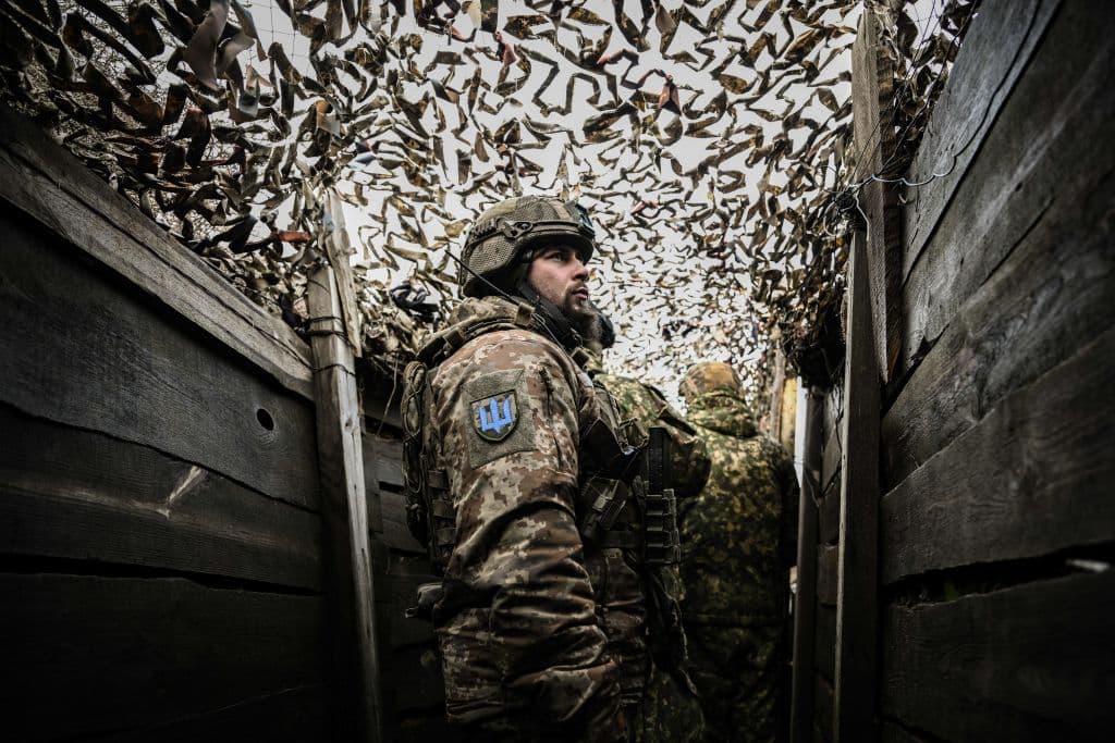 TOPSHOT - Ukrainian troops patrol at the frontline outside the town of Novoluhanske, eastern Ukraine, on February 19, 2022. - Ukraine's army said Saturday that two of its soldiers died in attacks in on the frontline with Russian-backed separatists, the first fatalities in the conflict in more than a month. "As a result of a shelling attack, two Ukrainian servicemen received fatal shrapnel wounds," the military command for the separatist conflict said. (Photo by ARIS MESSINIS / AFP) (Photo by ARIS MESSINIS/AFP via Getty Images)