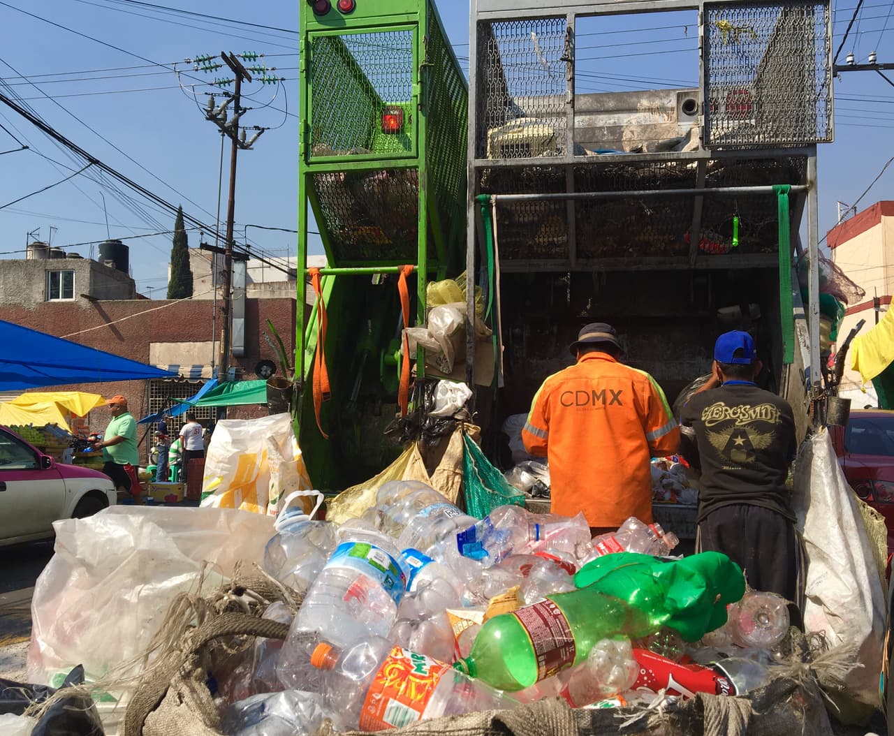 In a street in Mexico City, volunteers in a garbage truck separate recyclable materials from the trash to sell them. They live off the sale of these products and tips from homeowners and businesses, since they do not have a government salary.