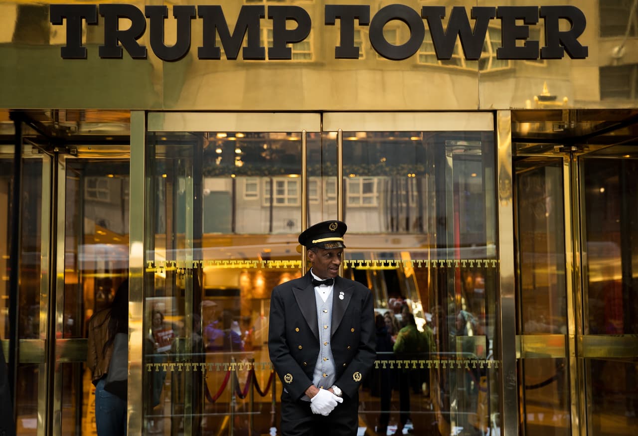 NEW YORK, NEW YORK - SEPTEMBER 29: A doorman stands at the entrance of Trump Tower as protestors rally against Republican presidential candidate Donald Trump, September 29, 2016 in New York City. The protest was organized by Jewish social action group 'Bend the Arc Jewish Action.' (Photo by Drew Angerer/Getty Images)